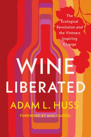 Book cover for 'Wine Liberated' by Adam L. Huss featuring colorful abstract bottle shapes and a red leaf motif