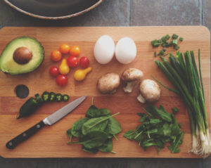 Cutting board with vegetables and a knife