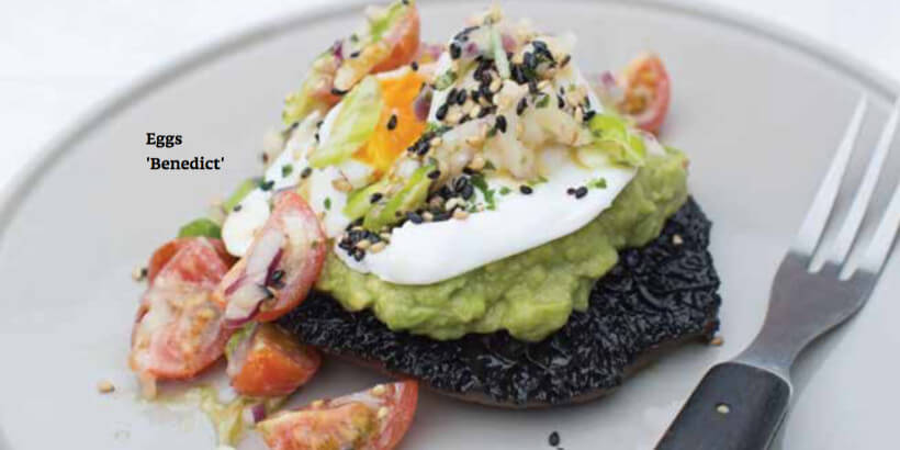 Portobella mushroom topped with avocado, poached eggs, tomatoes, and spices