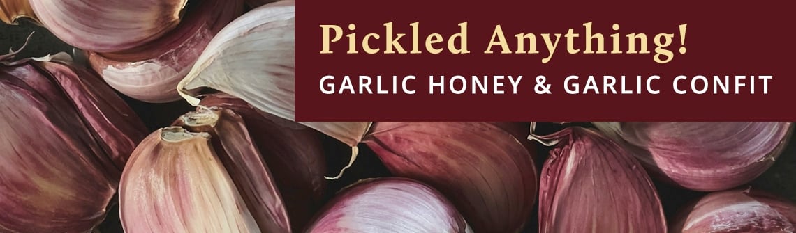 Close-up of red onions with a maroon banner displaying 'Pickled Anything! Garlic Honey & Garlic Confit'—advertising garlic pickled products.