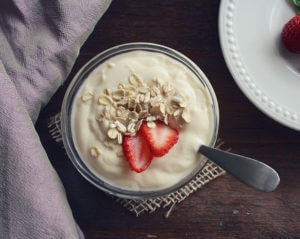 bowl of yogurt with strawberries and granola