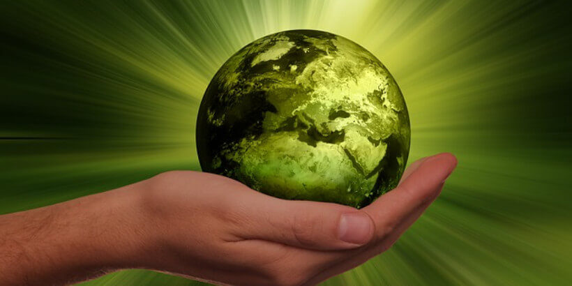 hand holding a green earth