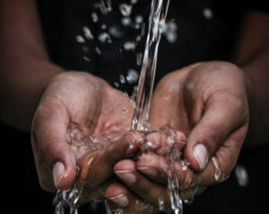 water pouring onto hands