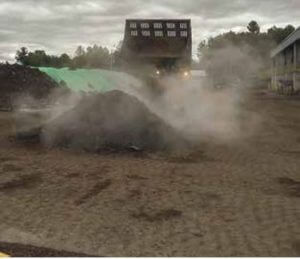 Water truck adding moisture to compost