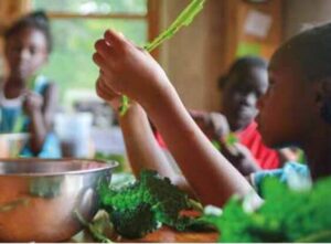 kid with vegetables