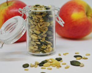 apples and apple seeds in a glass jar