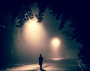 person standing under a streetlight at night